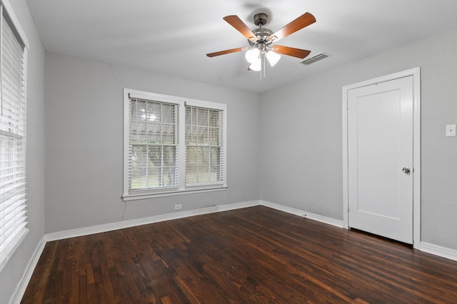 spare room featuring ceiling fan and dark hardwood / wood-style flooring