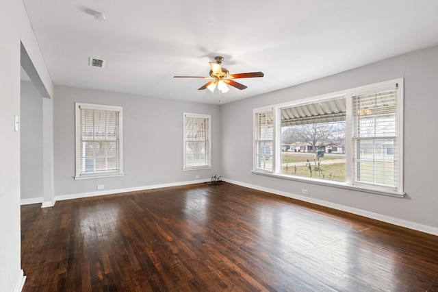 unfurnished room with dark hardwood / wood-style flooring and ceiling fan