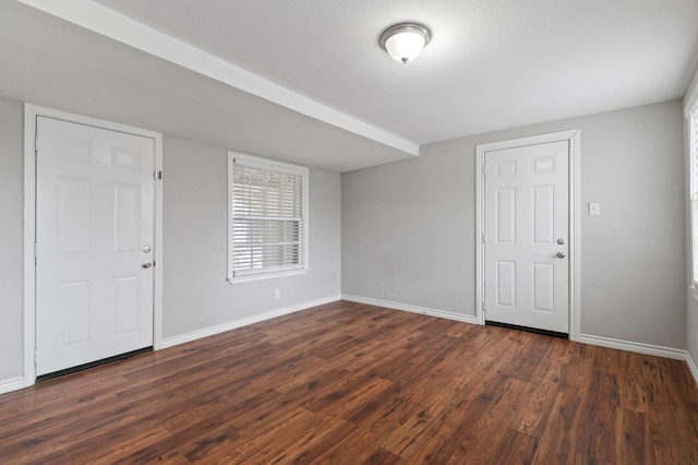 unfurnished room with dark wood-type flooring