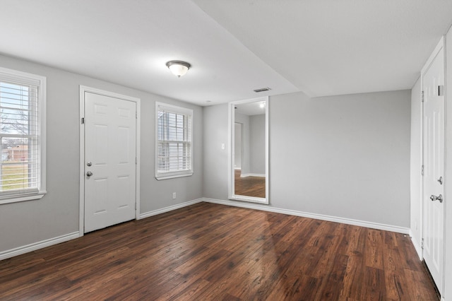 unfurnished bedroom featuring dark hardwood / wood-style flooring