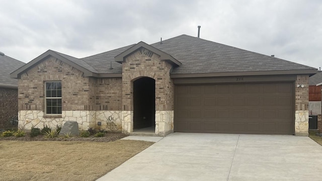 view of front of house featuring a garage and a front lawn