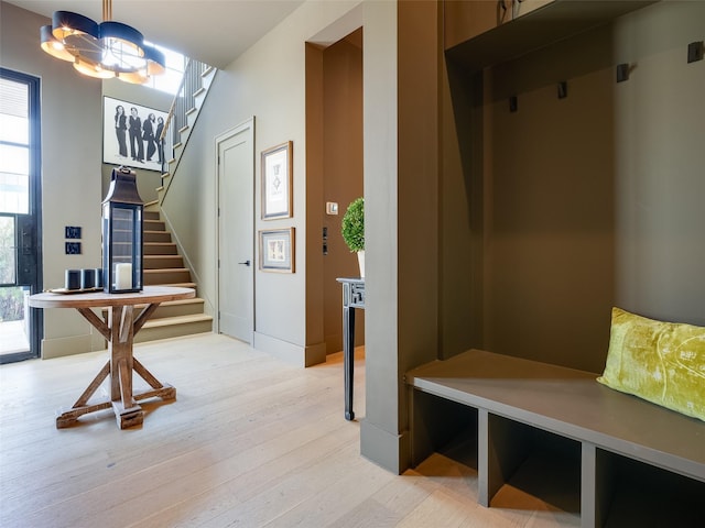 mudroom featuring a notable chandelier and light hardwood / wood-style floors