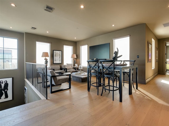 dining room with light hardwood / wood-style flooring and plenty of natural light