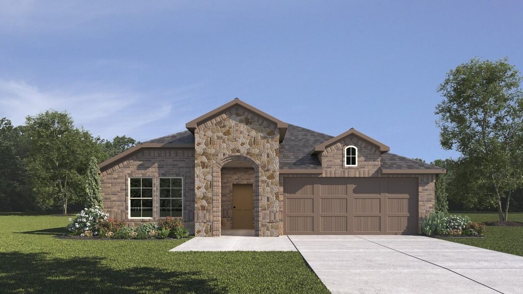 view of front of house featuring a garage and a front lawn