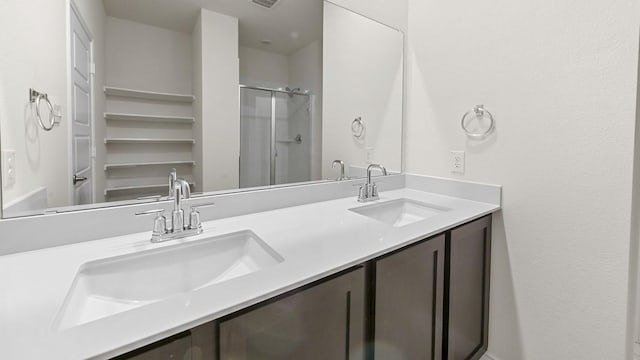 full bathroom featuring a sink, visible vents, a stall shower, and double vanity