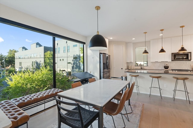 dining room featuring hardwood / wood-style floors and sink