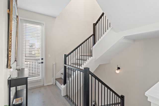 stairway featuring wood-type flooring