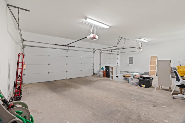 garage featuring electric panel and a garage door opener