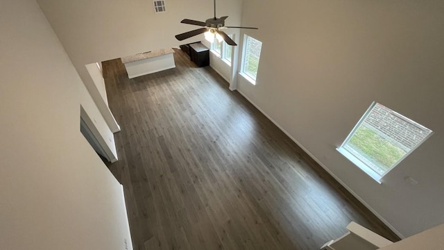 4237 Zayan Dr, Sherman, TX 75090 - unfurnished living room with healthy amount of natural light, a ceiling fan, dark wood-style floors, and a towering ceiling
