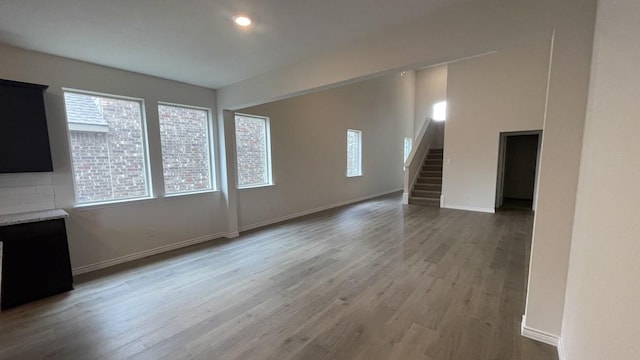 4237 Zayan Dr, Sherman, TX 75090 - unfurnished living room with stairs, wood finished floors, baseboards, and recessed lighting