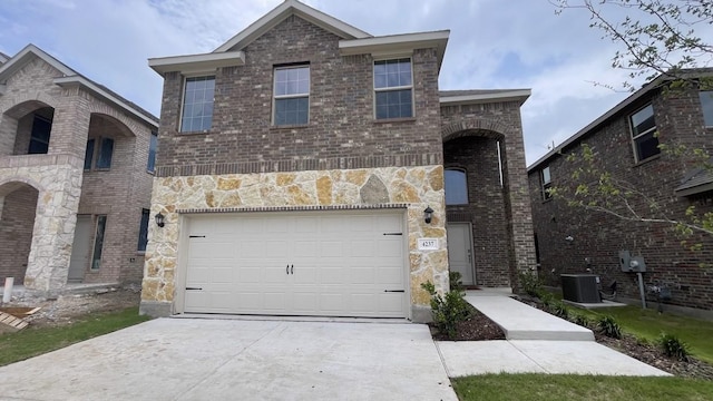4237 Zayan Dr, Sherman, TX 75090 - view of front of property featuring driveway, central air condition unit, a garage, brick siding, and stone siding