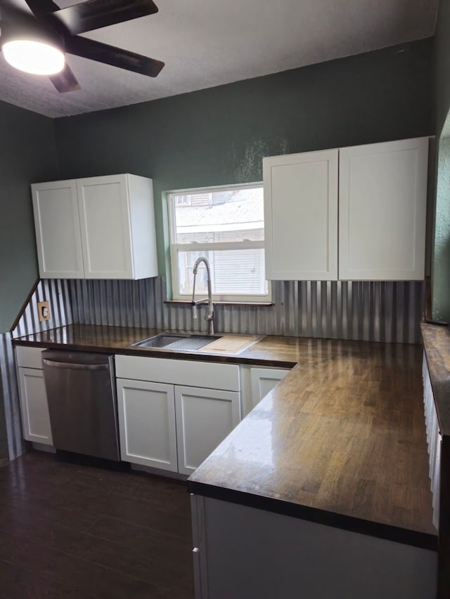 kitchen featuring decorative backsplash, stainless steel dishwasher, ceiling fan, sink, and white cabinets