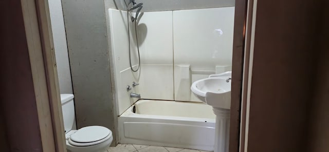 bathroom with tile patterned flooring, shower / bathing tub combination, and toilet