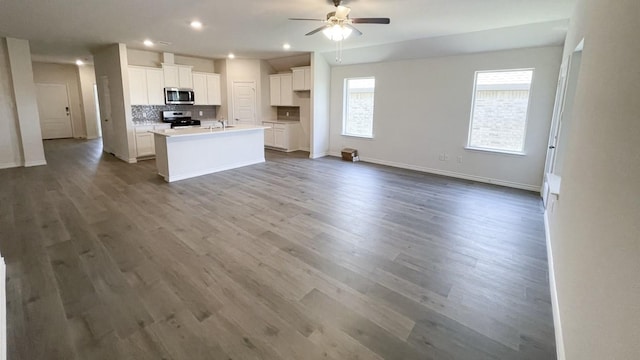 4208 Lucy Ln, Sherman, TX 75090 - kitchen featuring appliances with stainless steel finishes, a ceiling fan, open floor plan, dark wood-type flooring, and recessed lighting