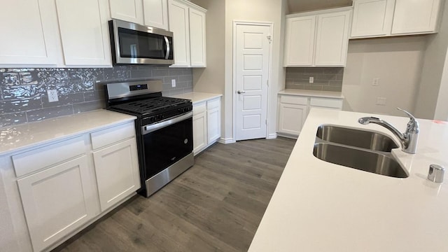 4208 Lucy Ln, Sherman, TX 75090 - kitchen featuring stainless steel appliances, a sink, dark wood-style flooring, and white cabinetry