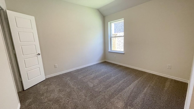 4208 Lucy Ln, Sherman, TX 75090 - empty room with dark colored carpet, lofted ceiling, and baseboards