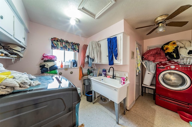 laundry room featuring cabinets, a textured ceiling, washer and clothes dryer, ceiling fan, and sink