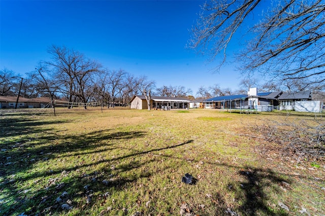 view of yard featuring a storage shed and a trampoline