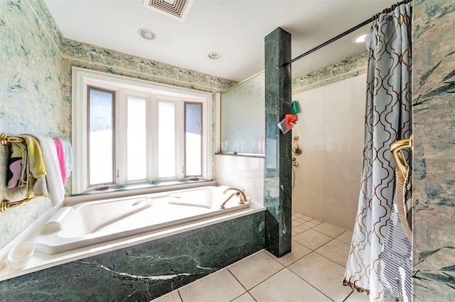 bathroom featuring tile patterned flooring and shower with separate bathtub