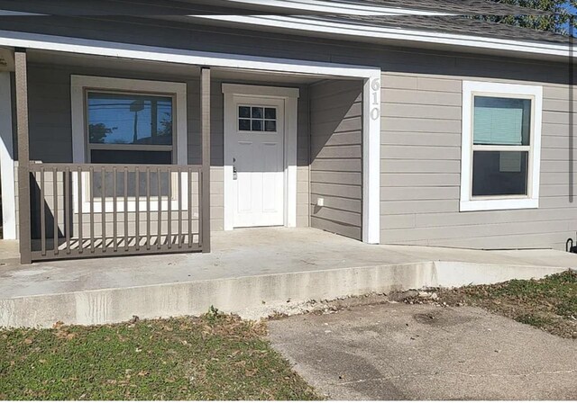 doorway to property with a porch