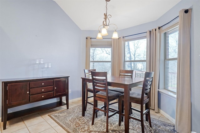 tiled dining area with an inviting chandelier and vaulted ceiling