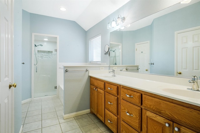 bathroom featuring tile patterned floors, lofted ceiling, vanity, and a shower with shower door