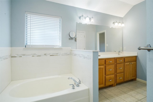 bathroom featuring vanity, tile patterned floors, vaulted ceiling, and a tub