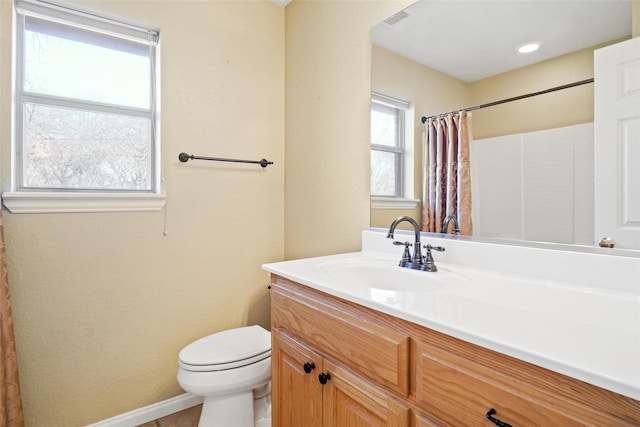 bathroom featuring walk in shower, tile patterned flooring, vanity, and toilet