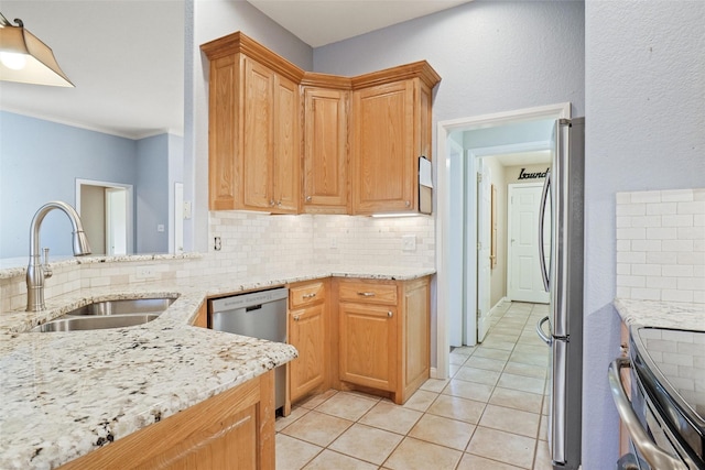 kitchen featuring appliances with stainless steel finishes, light stone countertops, light tile patterned floors, decorative backsplash, and sink