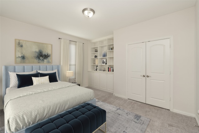 bedroom with light carpet and a closet