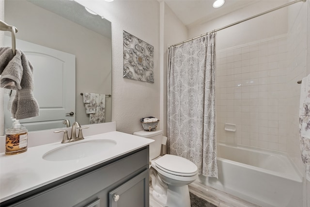 full bathroom featuring vanity, shower / tub combo, and toilet