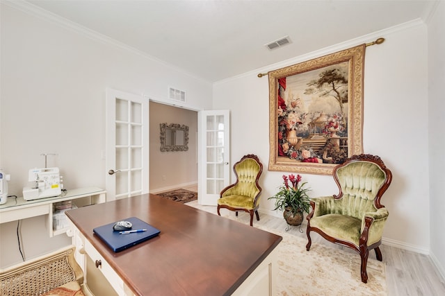 office space featuring french doors, ornamental molding, and light hardwood / wood-style flooring