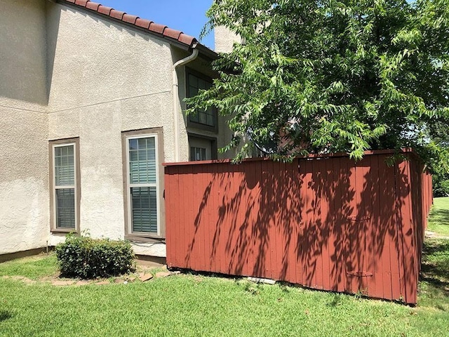 view of property exterior featuring a lawn