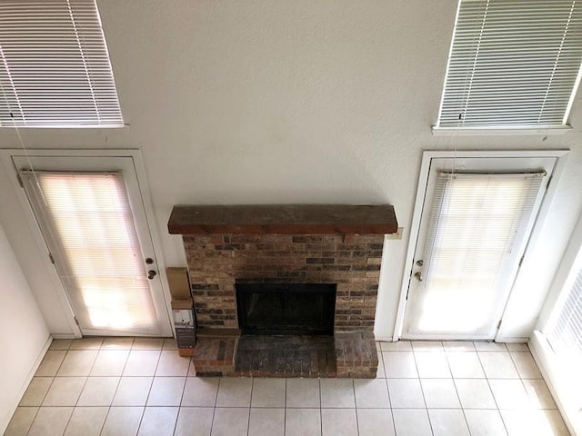 unfurnished living room featuring light tile patterned floors and a fireplace