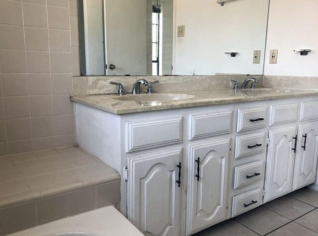 bathroom featuring tile patterned flooring and vanity