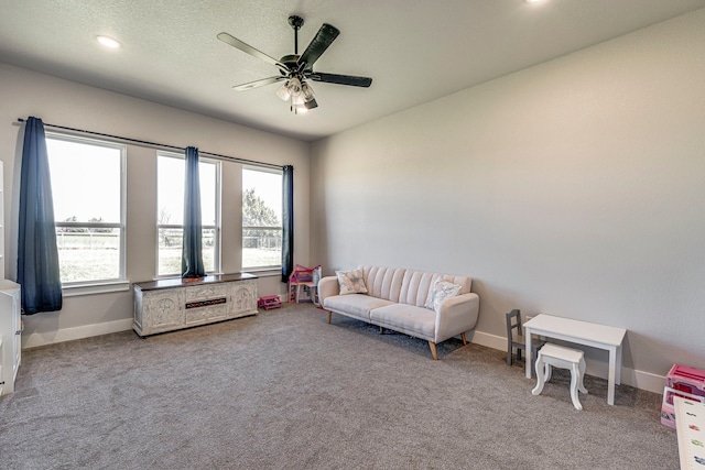 sitting room with carpet flooring and ceiling fan