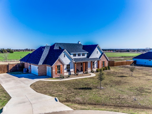 modern inspired farmhouse with a front lawn and a garage