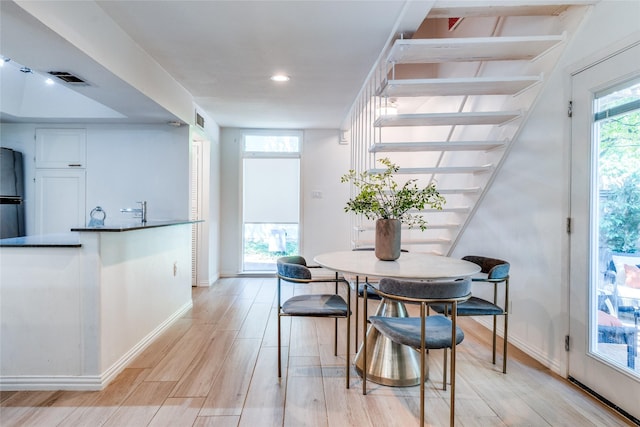 dining space with light hardwood / wood-style flooring