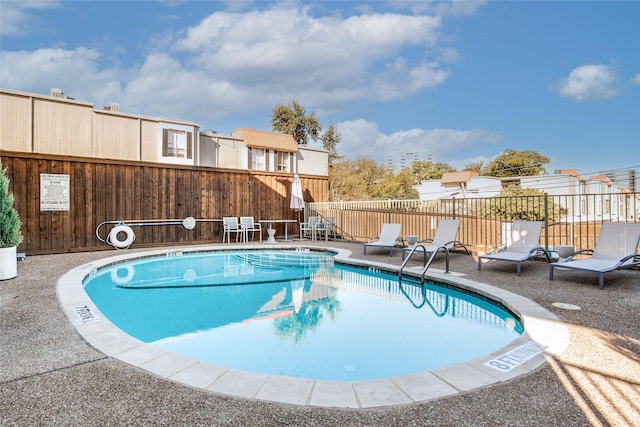 view of swimming pool with a patio area