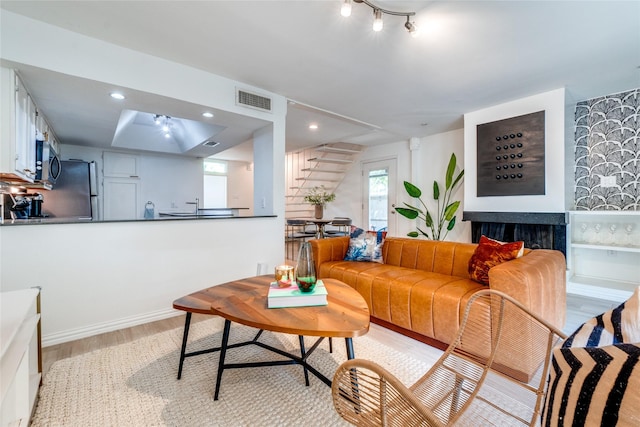 living room featuring sink and light hardwood / wood-style floors