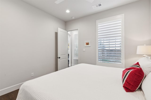 bedroom featuring ceiling fan and dark hardwood / wood-style flooring