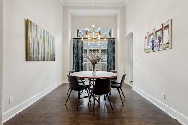 dining area with a notable chandelier, crown molding, and dark wood-type flooring