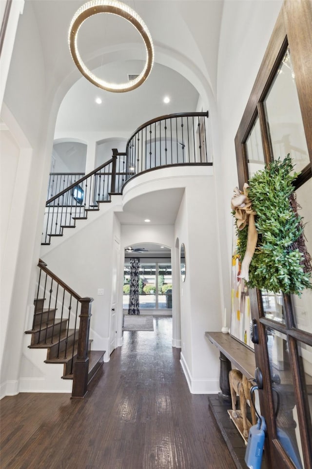 foyer featuring dark hardwood / wood-style flooring and a towering ceiling