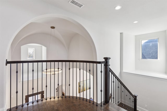 corridor with hardwood / wood-style floors