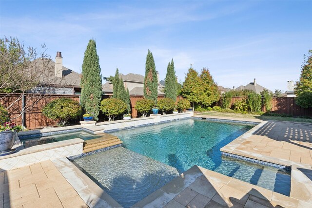 view of pool with an in ground hot tub and a patio area