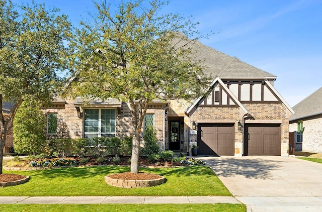 view of front of house with a garage and a front lawn