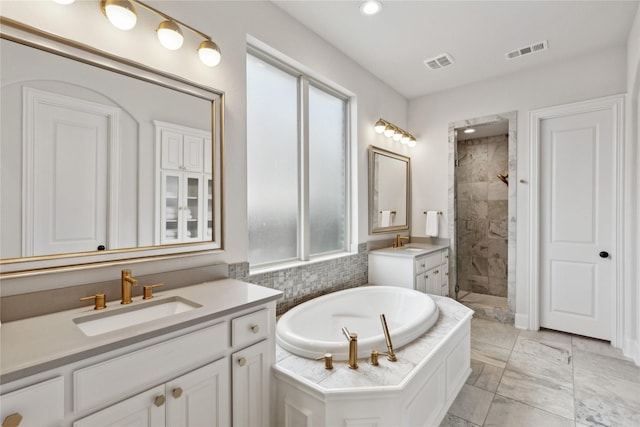 bathroom featuring vanity, plenty of natural light, and separate shower and tub