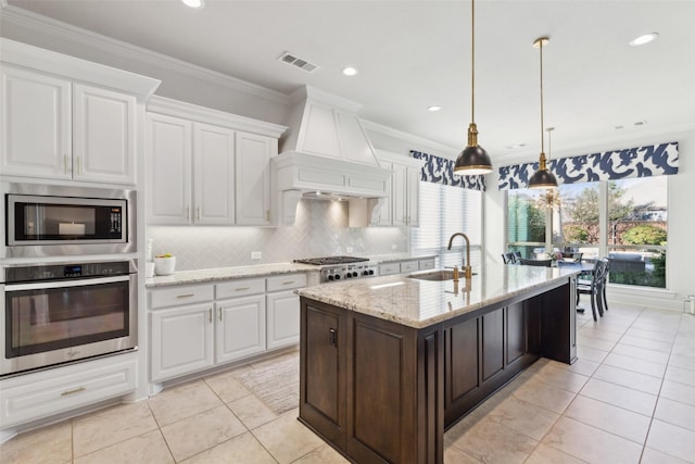 kitchen with pendant lighting, white cabinetry, sink, ornamental molding, and stainless steel appliances