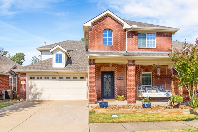 view of front of home featuring a porch, a garage, and central air condition unit