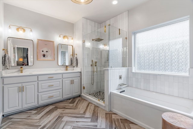 bathroom featuring vanity and separate shower and tub